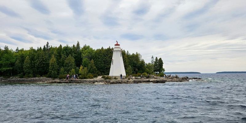 a lighthouse on a small island in the middle of the ocean
